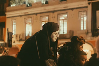 A nighttime outdoor scene near the Smithsonian museums with a small gathering of kink enthusiasts preparing for a local event.
