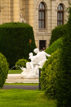 A beautifully carved marble sculpture displayed in a garden.