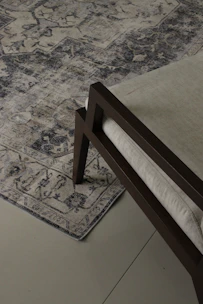 A washable chenille rug with a subtle pattern laid out in a bright, airy room.