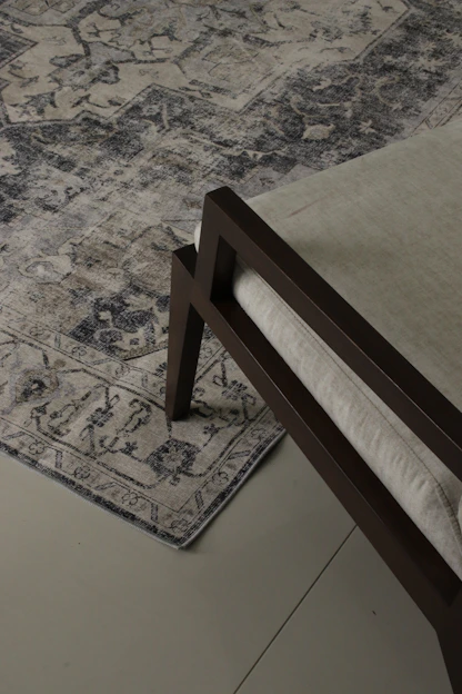 A stylish abstract indoor rug displayed in a modern living room.