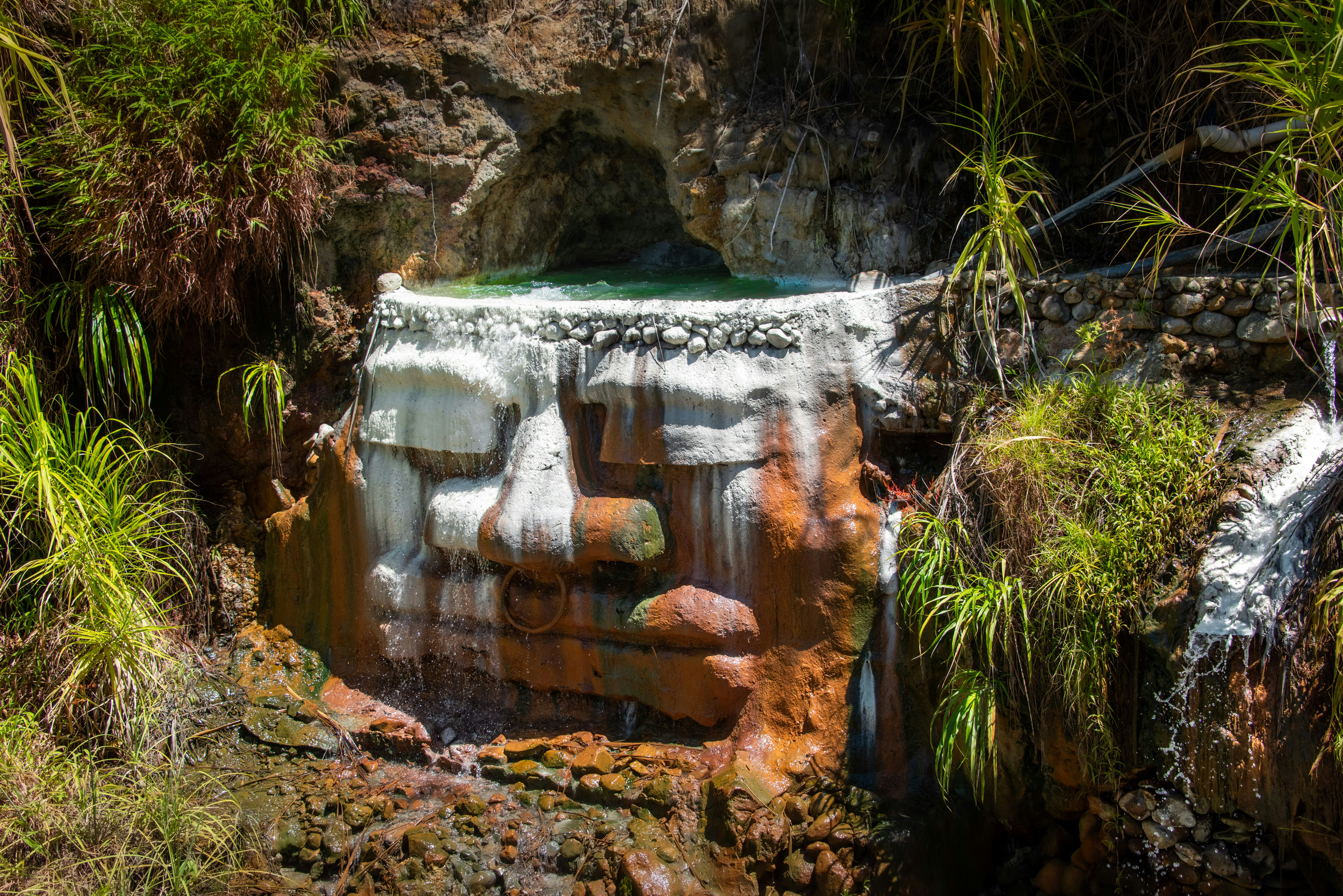 a small waterfall in the middle of a forest