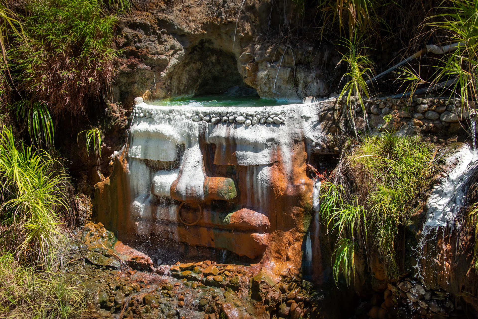 a small waterfall in the middle of a forest