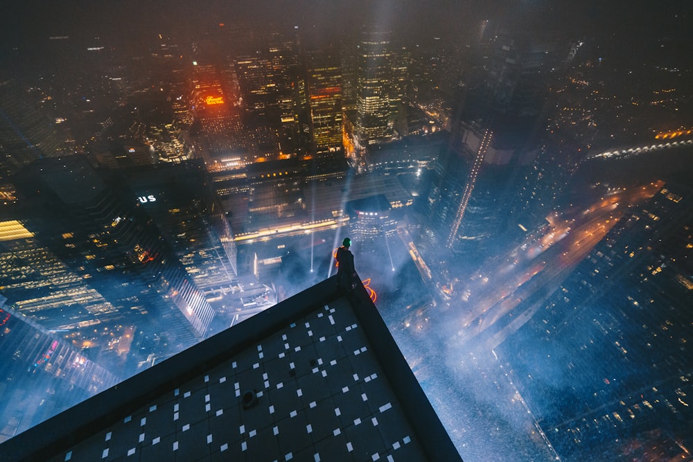 a person standing on top of a tall building