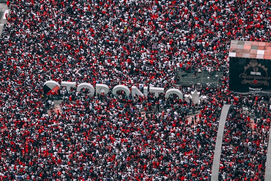 An exciting atmosphere at a Raptors watch party with fans cheering and celebrating.