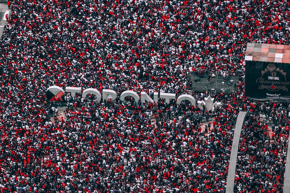 a large crowd of people are gathered in a stadium