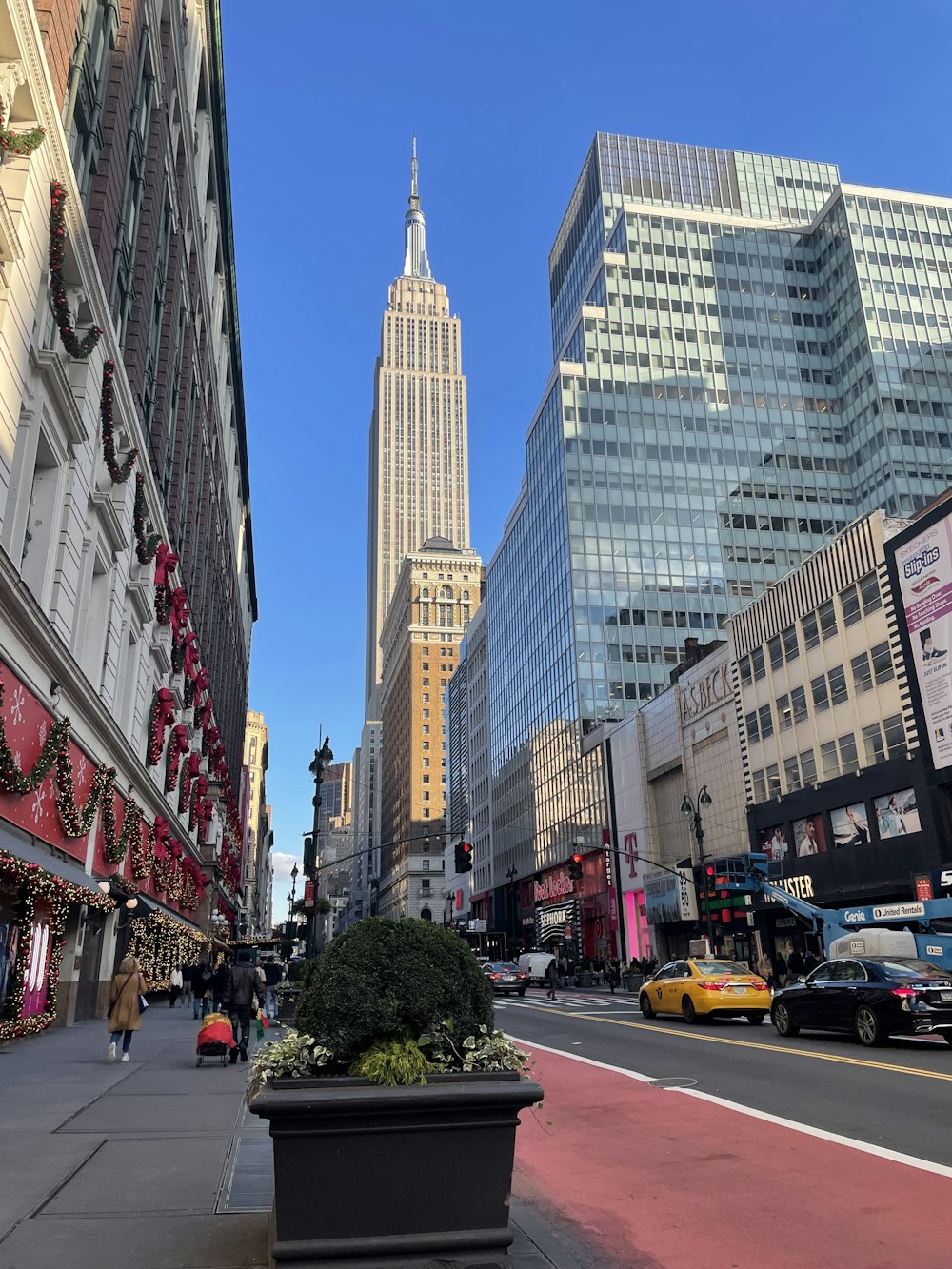 a city street with tall buildings in the background