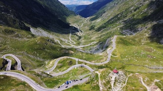 A scenic landscape featuring mountains and a winding road, inviting travelers to explore.
