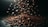 Coffee beans are cascading through the air and forming a pile on a dark surface, with dramatic lighting highlighting their textures.
