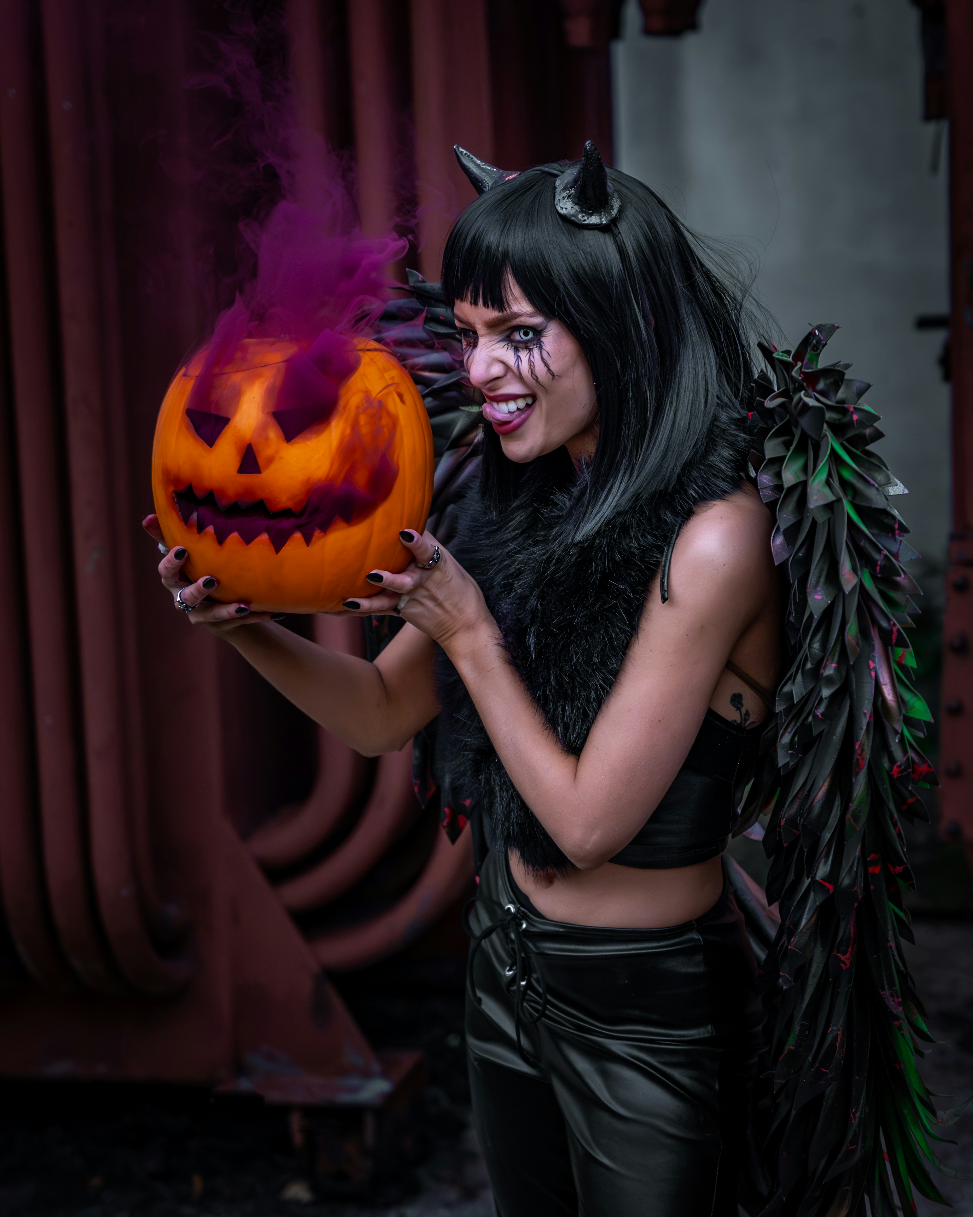 a woman in a costume holding a pumpkin