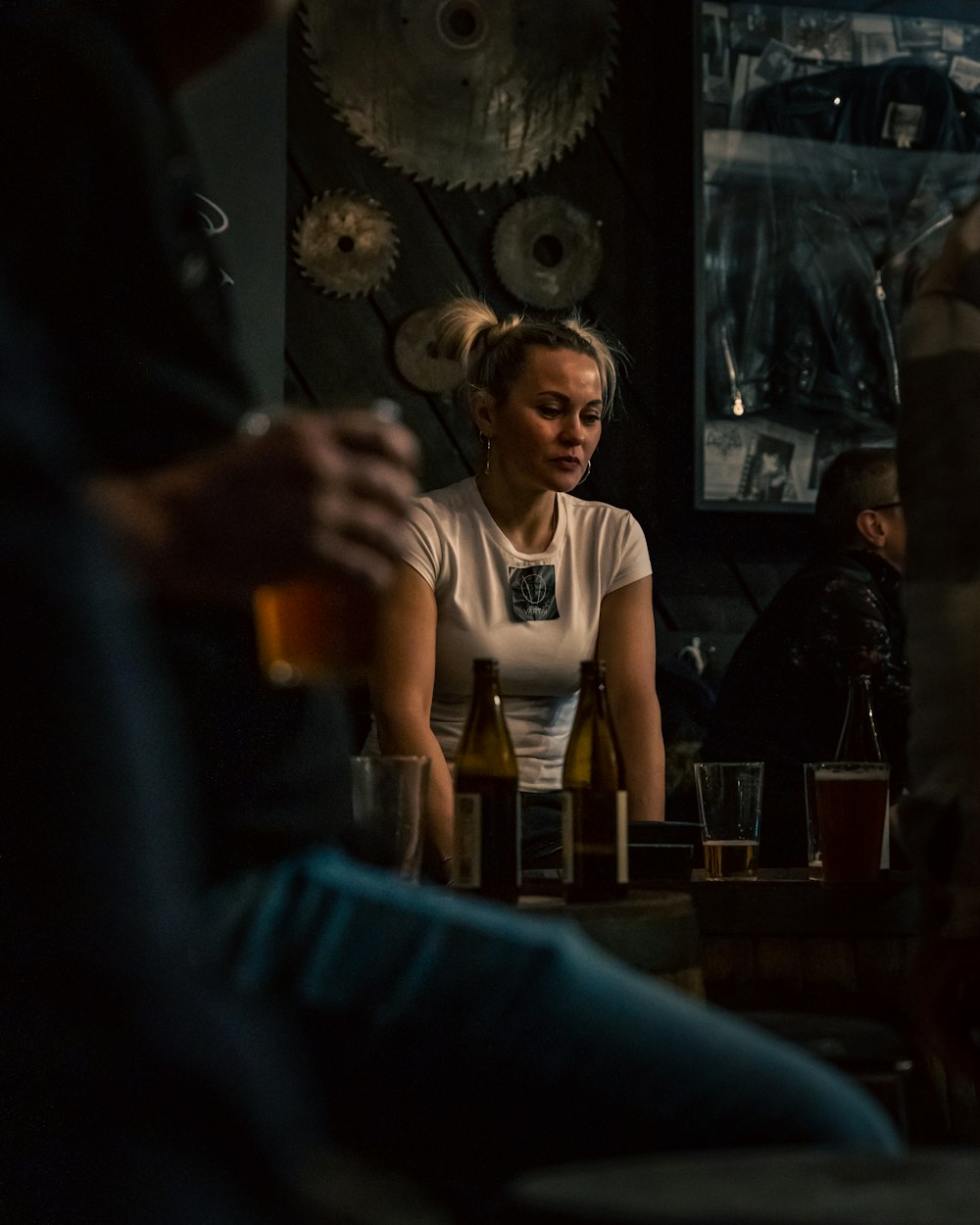 a woman sitting at a table with a glass of wine