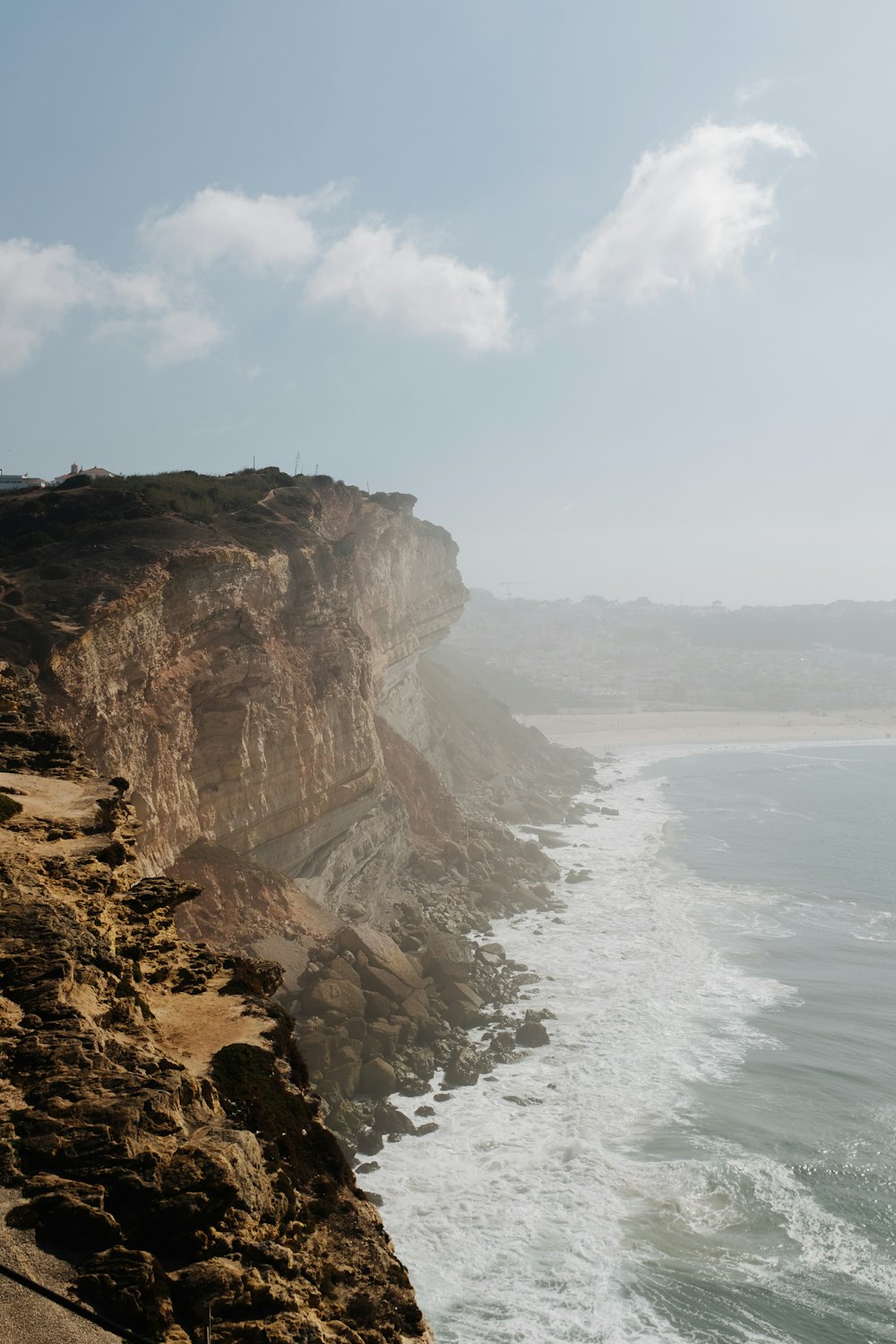 a cliff overlooking the ocean on a sunny day
