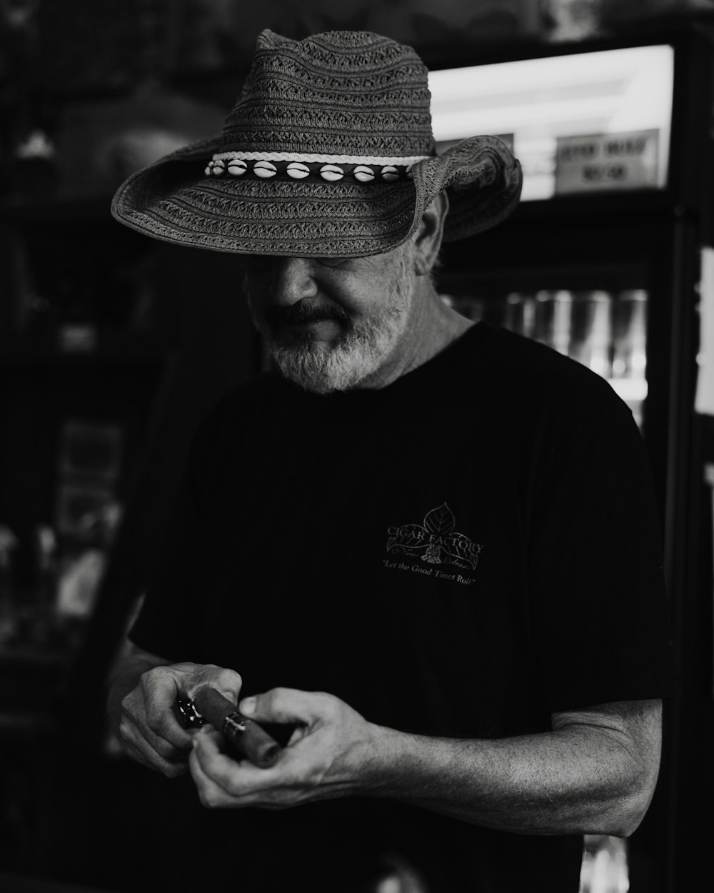 a man in a hat looking at his cell phone
