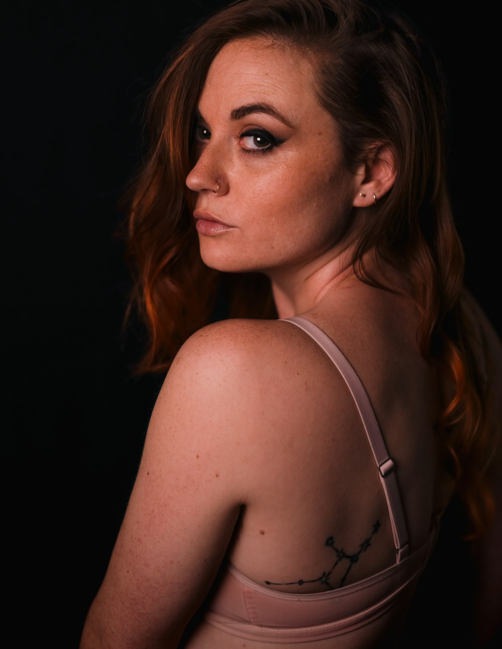 a woman with a tattoo on her shoulder