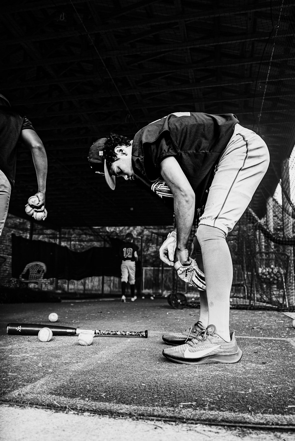 a black and white photo of two men playing baseball