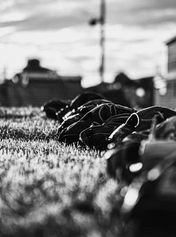 Close-up of stylish baseball gloves and cleats arranged neatly on a wooden bench.