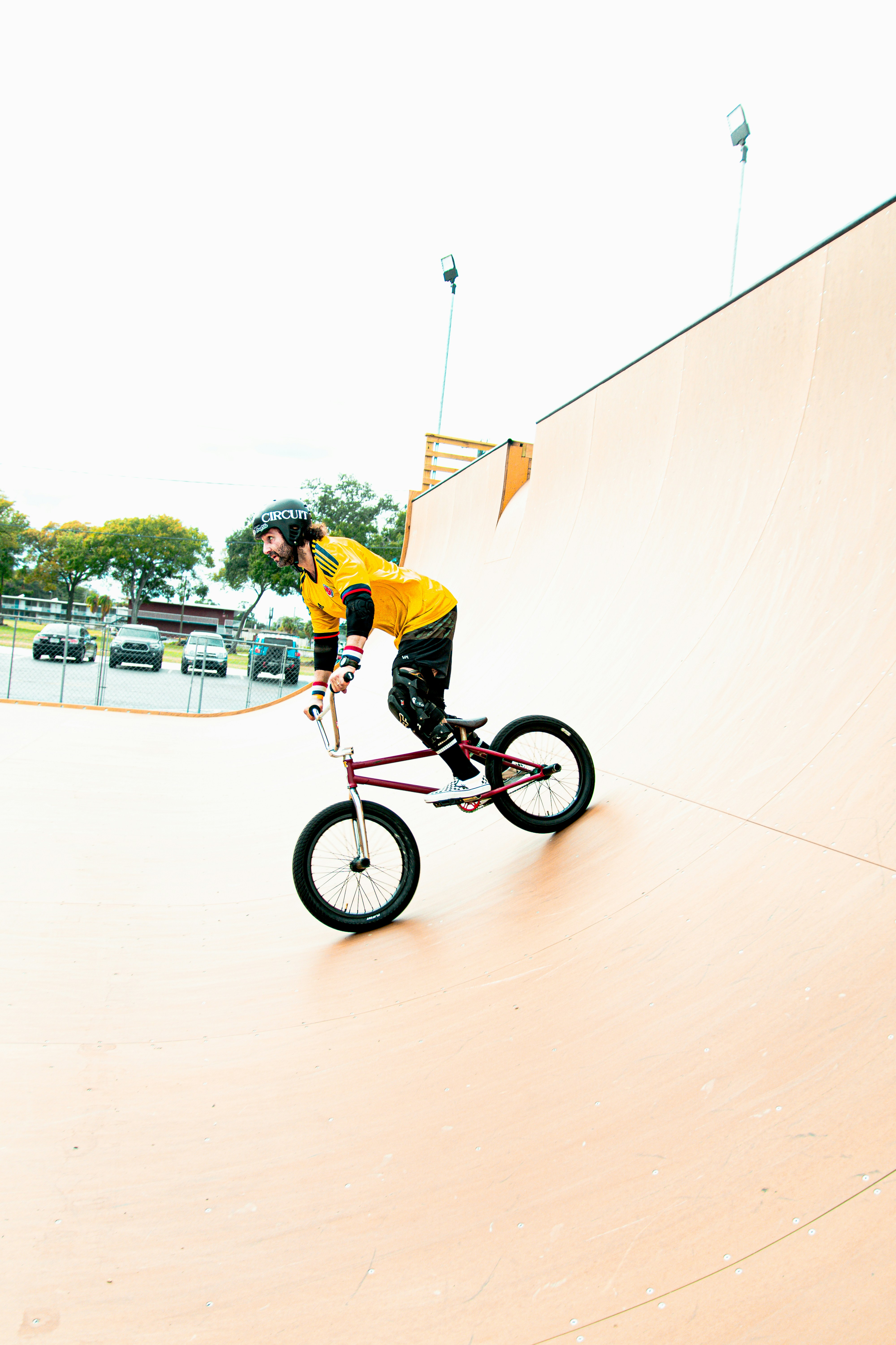 a man riding a bike up the side of a ramp