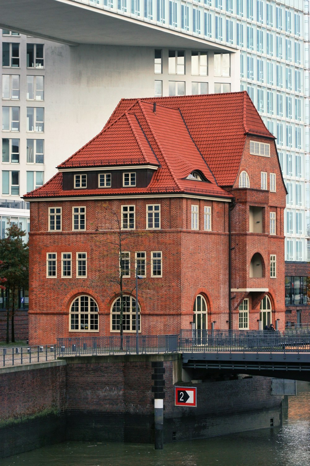 a red brick building with a bridge over it