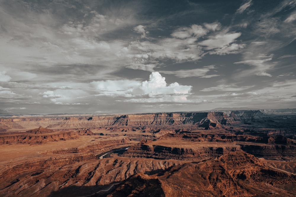 a scenic view of a canyon with a cloudy sky