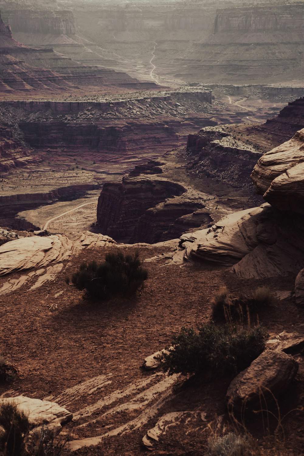 a man standing on a cliff overlooking a canyon