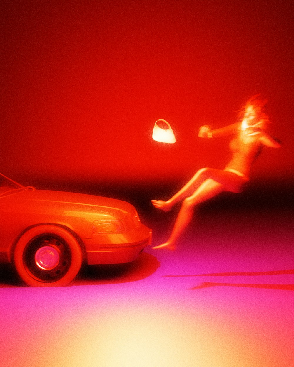 a woman sitting on a car in front of a red wall
