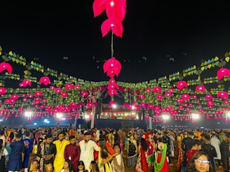 a large group of people standing around a festival