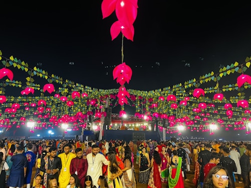 a large group of people standing around a festival