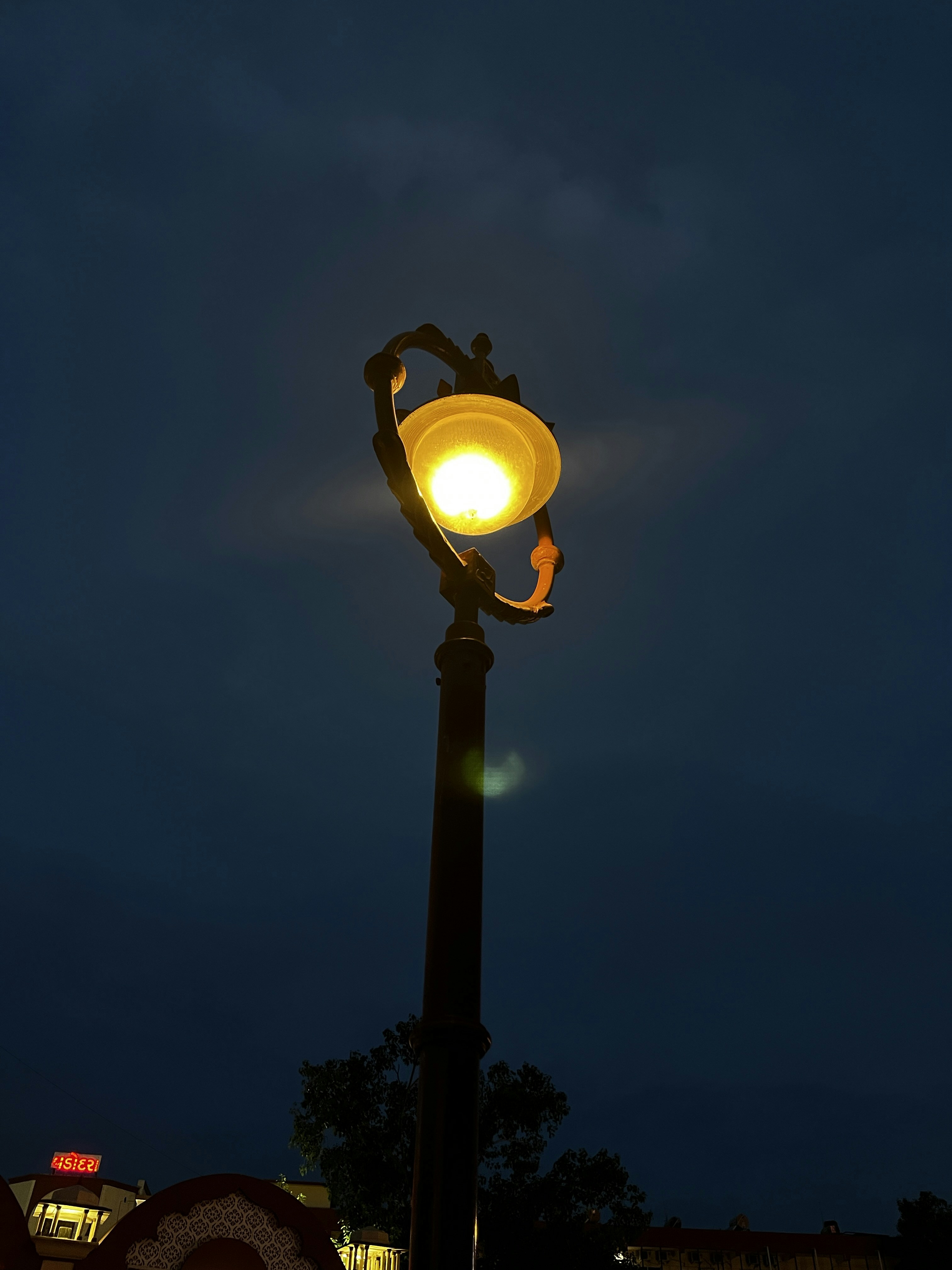 a lamp post with a street light on top of it