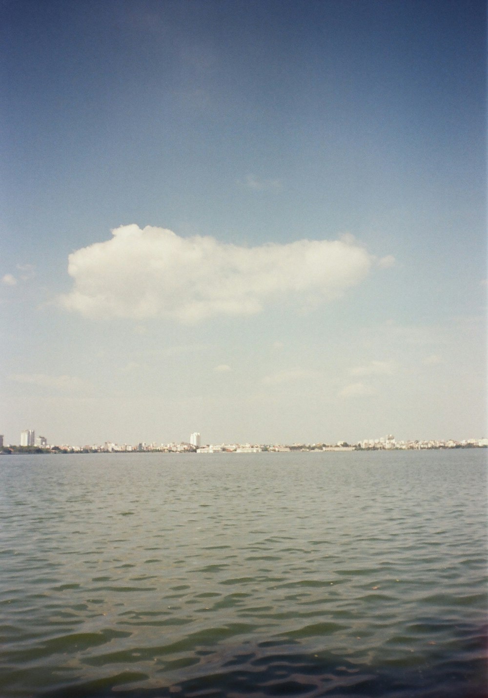 a large body of water with a city in the distance