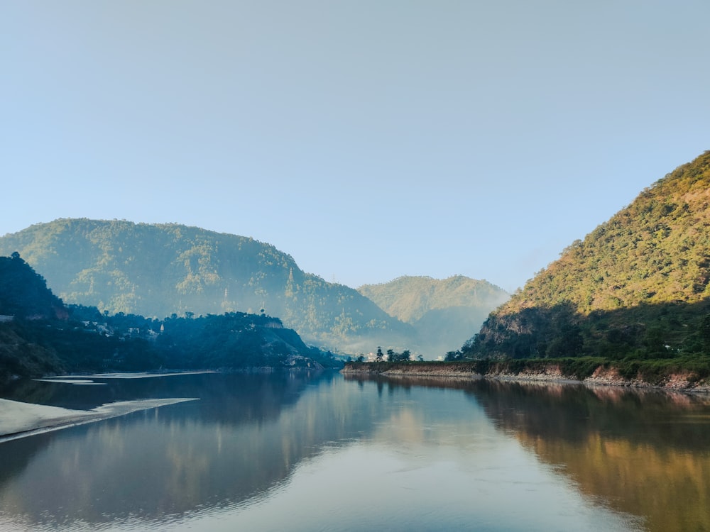 a body of water with mountains in the background