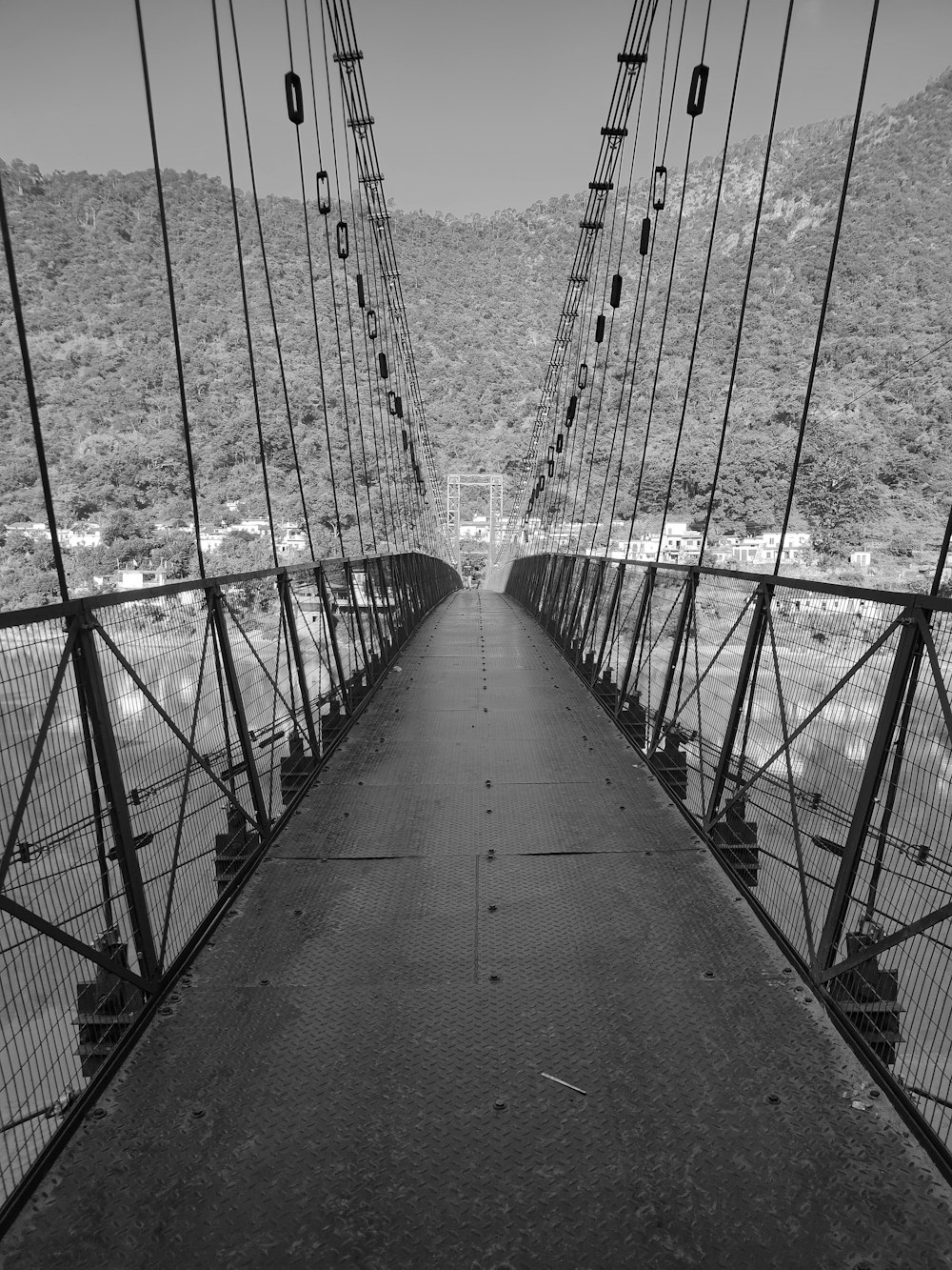 a black and white photo of a suspension bridge