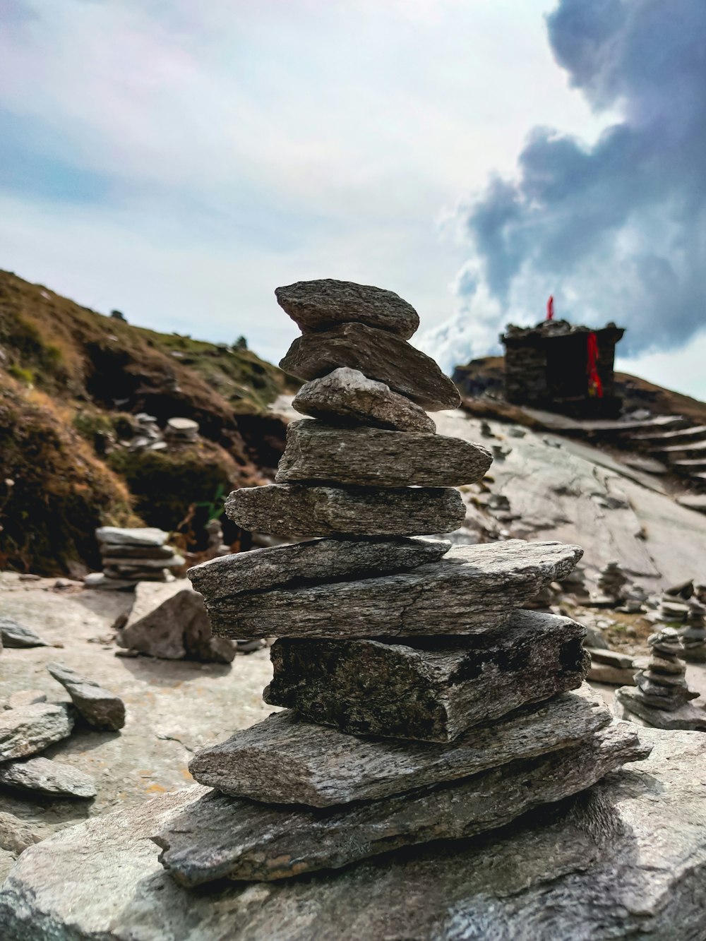 a stack of rocks sitting on top of a rocky hillside