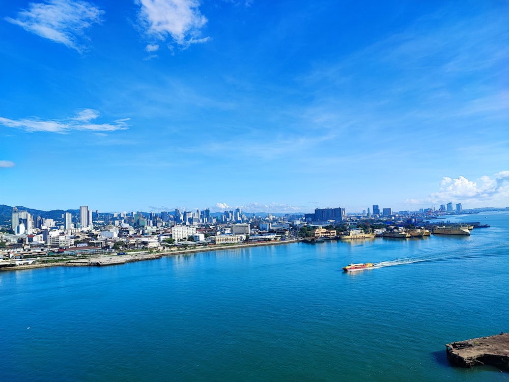 a large body of water with a city in the background