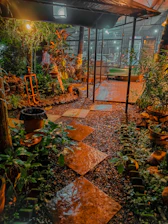 A cozy backyard illuminated by soft solar garden lights along a stone pathway at dusk.