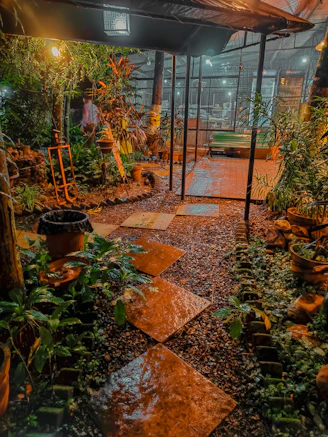 A cozy garden illuminated by warm solar pathway lights winding through lush greenery at dusk.