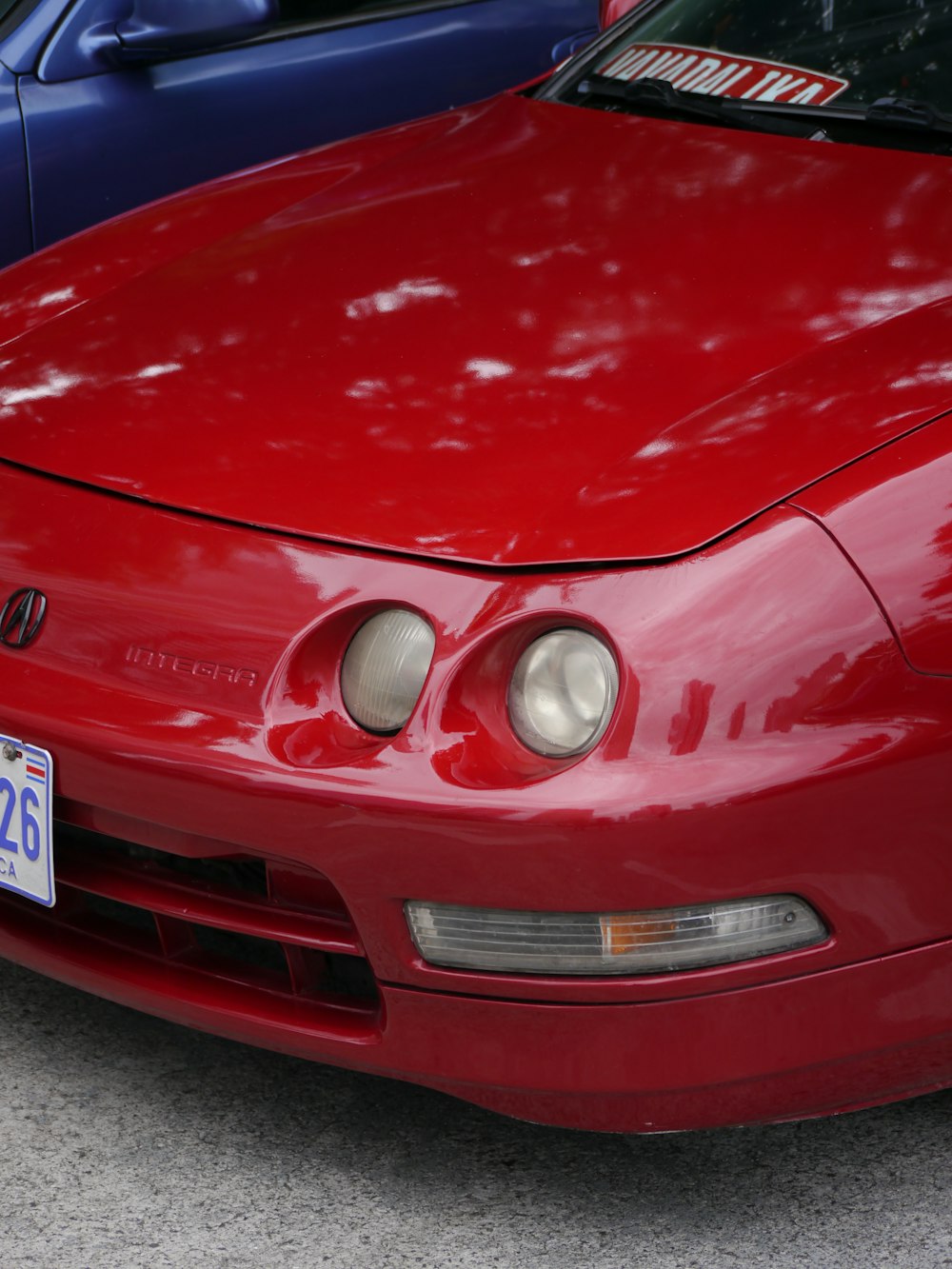 a red car parked next to a blue car