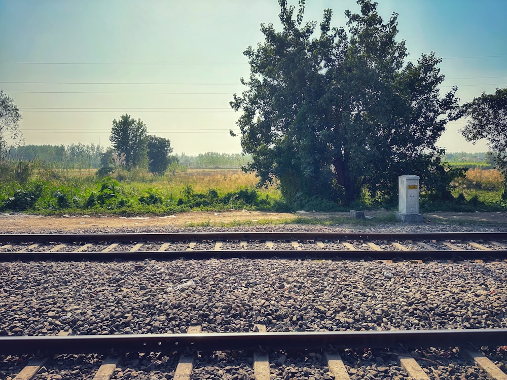 a train track with a small white box sitting on top of it