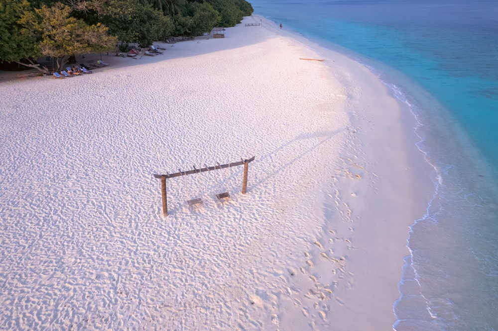 an aerial view of a beach with a volleyball court