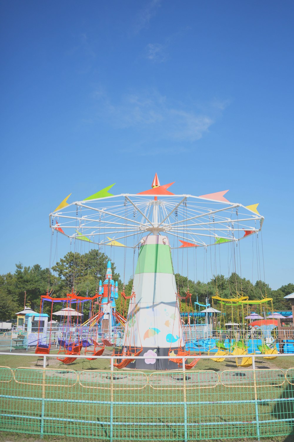 a carnival ride in a park on a sunny day