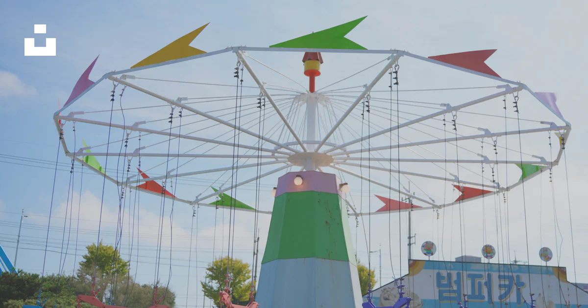 Fun Fair Ride With Flags A carnival ride with colorful flags on it photo – Free 테마파크 Image on ...