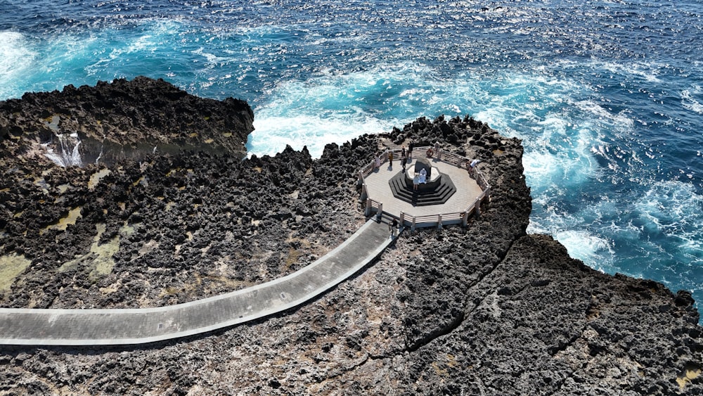 an aerial view of a walkway next to the ocean