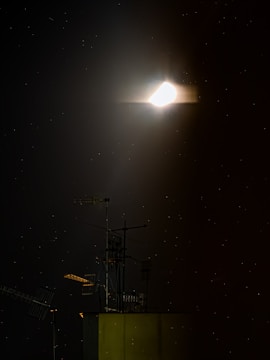 Close-up of a neutrino mesh beacon glowing softly against a dark sky.