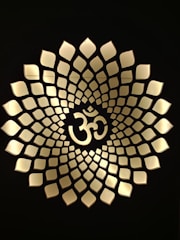 A serene golden Sri Yantra glowing softly against a deep saffron background, symbolizing harmony and energy.