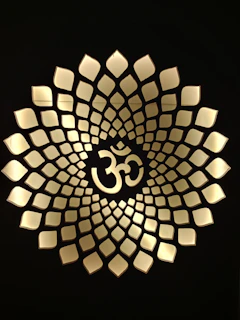 Detailed pencil drawing of the ॐ symbol surrounded by subtle floral patterns.