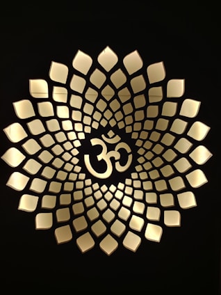 A serene golden Sri Yantra glowing softly against a deep saffron background, symbolizing harmony and energy.