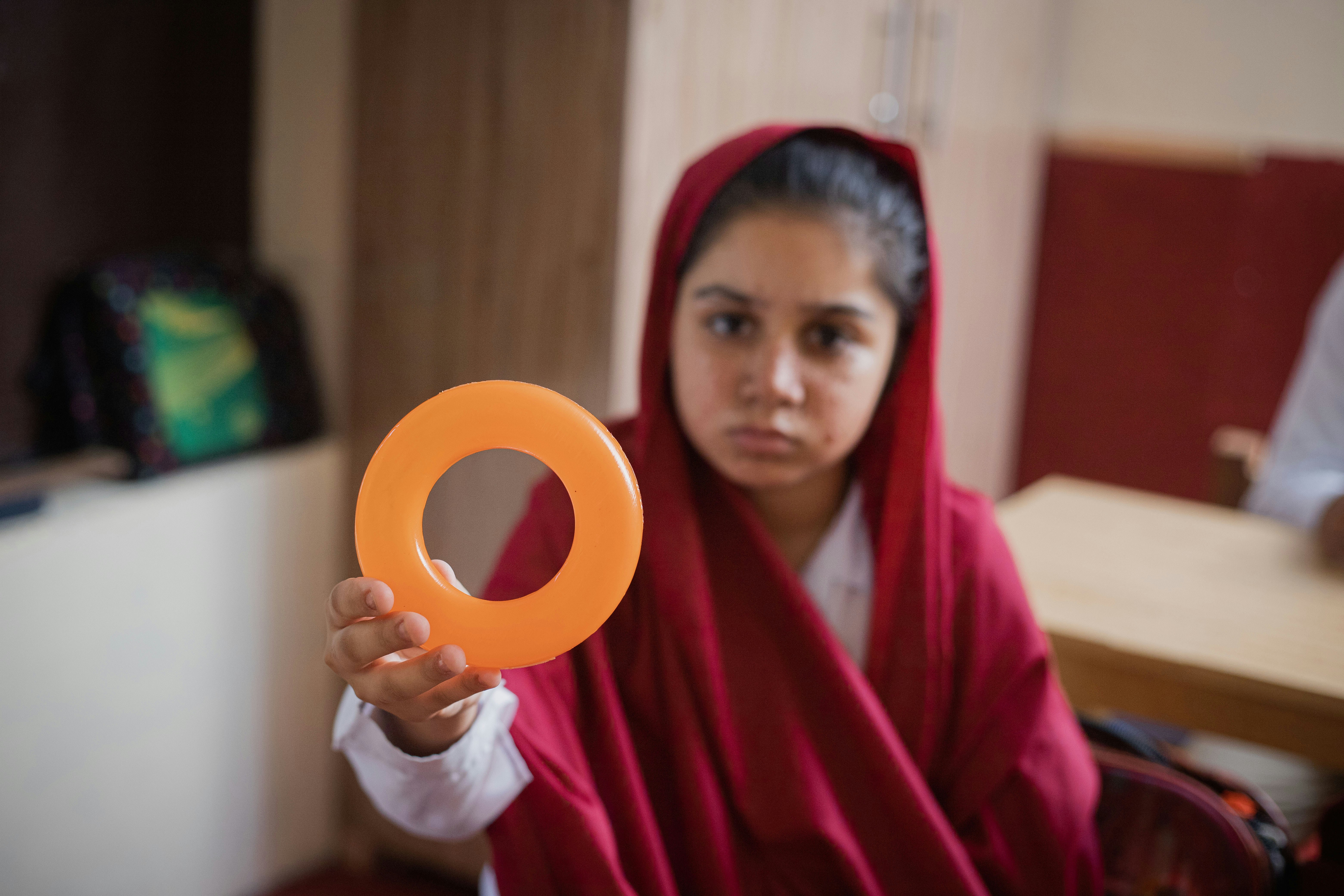 A Small student girl showing how to learn colors in Classroom