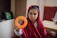 Smiling young girl concentrating on abacus beads during a bright classroom session