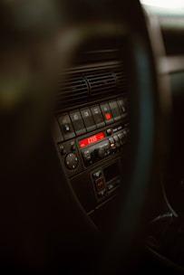 A close-up of a car dashboard featuring a multimedia system with various controls.