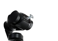 A robotic arm with a sleek, black design holds a series of lenses that appear to be suspended in mid-air. The background is a stark white, emphasizing the mechanical and sophisticated nature of the robotic technology.