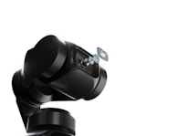 A robotic arm with a sleek, black design holds a series of lenses that appear to be suspended in mid-air. The background is a stark white, emphasizing the mechanical and sophisticated nature of the robotic technology.