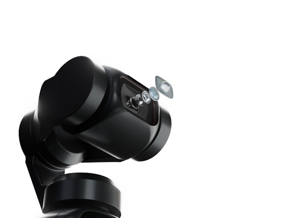 A robotic arm with a sleek, black design holds a series of lenses that appear to be suspended in mid-air. The background is a stark white, emphasizing the mechanical and sophisticated nature of the robotic technology.
